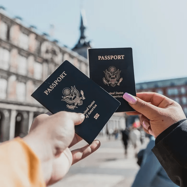 Two passports held in front of a hotel destination